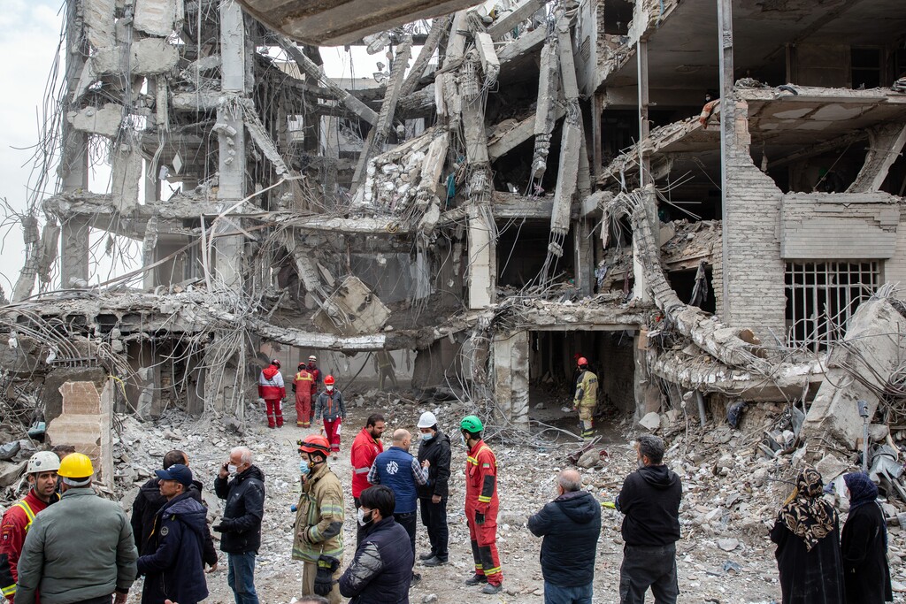 (Arash Khamooshi | The New York Times) Volunteers with Iran's Red Crescent at the site of a missile strike in Tehran on Thursday, March 12, 2026. Fighting has displaced up to 3.2 million people inside Iran, the United Nations refugee agency said on Thursday, as the human toll of the conflict rose.