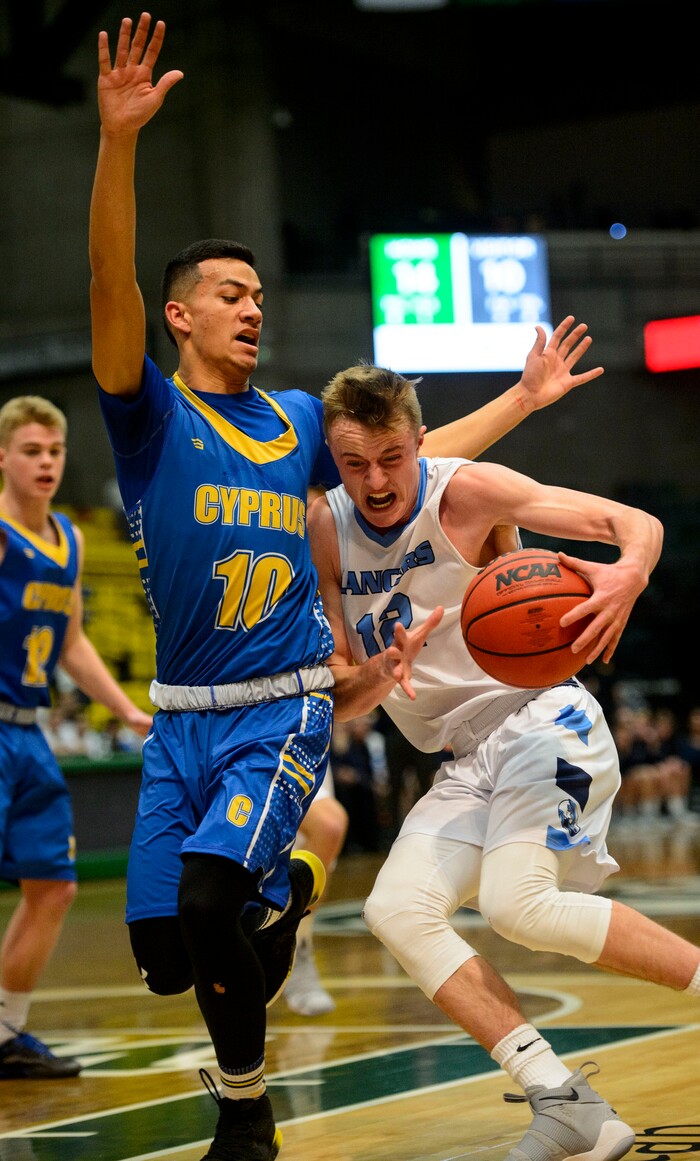(Steve Griffin  |  The Salt Lake Tribune) Layton's Truman Brown drives into Cyprus guard Josh Amasio during 6A basketball playoff game at the Utah Valley UniversityÕs UCCU Center in Provo Tuesday Feb. 27, 2018.