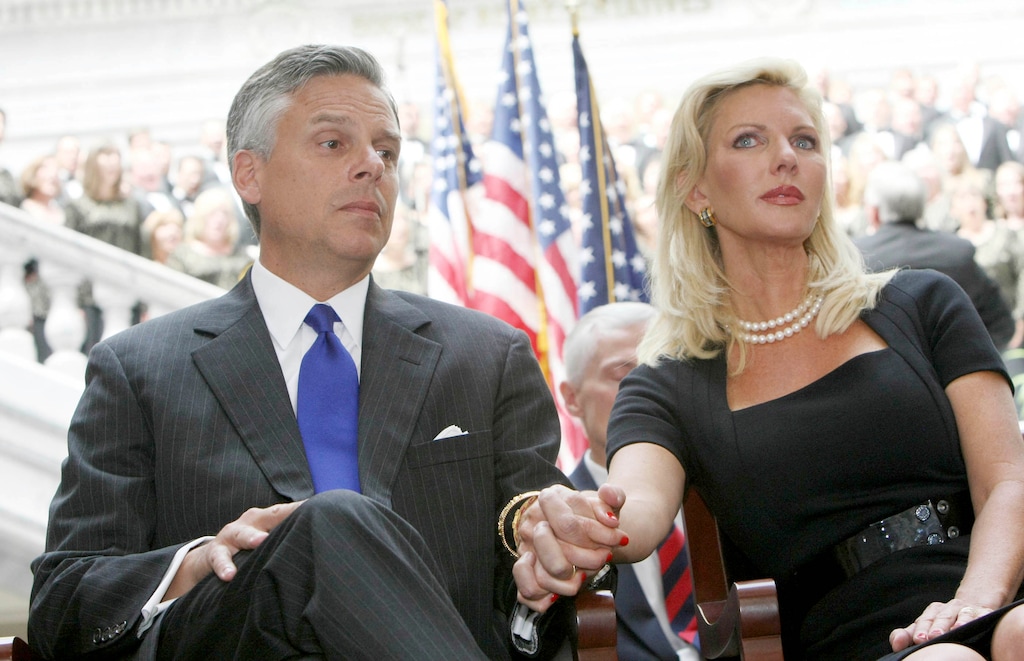 (Keith Johnson, pool) In this Aug. 11, 2009, file photo, then-Ambassador and former Gov. Jon Huntsman holds the hand of his wife Mary Kaye during Lt. Governor Gary Herbert's inauguration as Utah's new governor at the Utah State Capitol in Salt Lake City. Mary Kaye Huntsman disclosed on Thursday that she has tested positive for the coronavirus days after Jon Huntsman.