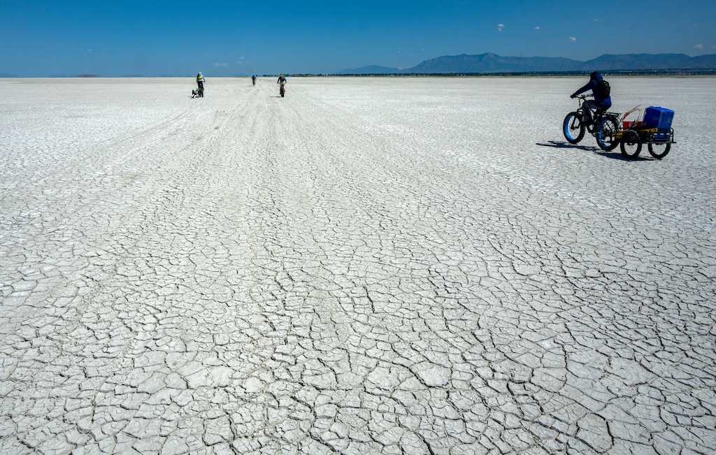 (Rick Egan | The Salt Lake Tribune) Bill Johnson's and University of Utah graduate students haul their equipment  out onto the playa of the Great Salt Lake on Tuesday, June 17, 2025.