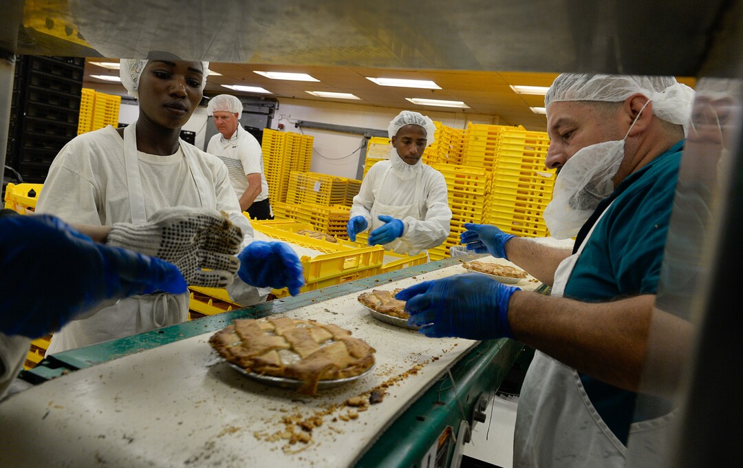 Francisco Kjolseth | The Salt Lake TribuneCrews pull recently baked hand laid lattice apple pie's at Rocky Mountain Pie factory in Salt Lake where the pies are made. 