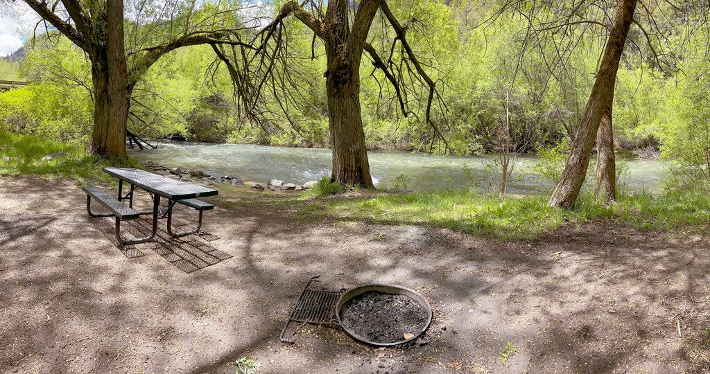 In this Thursday, May 21, 2020, photo, a campsite at Wood Camp sits along the Logan River, near Logan, Utah. With outdoor recreation being one of the few activities available during the COVID-19 pandemic, campsites are undergoing a large uptick in positive and negative use. Local forest rangers are encouraging folks to treat campgrounds respectfully, extinguish campfires and plan ahead for trips. (Eli Lucero/The Herald Journal via AP)