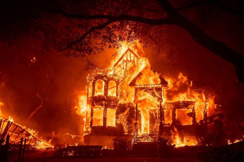(Noah Berger | AP photo)
In this Sept. 27 photo, Flames from the Glass Fire consume the Black Rock Inn in St. Helena, Calif. Deadly wildfires in California have burned more than 4 million acres (6,250 square miles) this year, a new record for the most acres burned in a single year. California fire officials said the state hit the fearsome milestone Sunday, Oct. 4, with about two months still left in the fire season.