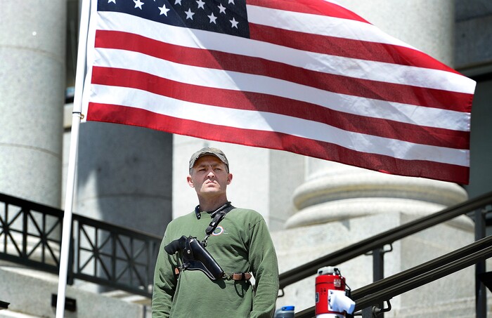 (Scott Sommerdorf | The Salt Lake Tribune) Steven Lund stood by with a gun strapped to his chest as a string of speakers addressed the crowd. A group calling themselves Citizens and Students For Liberty (SFL) gathered at the Utah State Capitol on Saturday to show their support for the Second Amendment, Saturday, April 14, 2018.