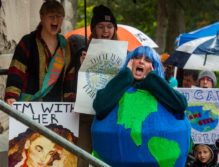 (Rick Egan  |  The Salt Lake Tribune)     Alee Lawlor, from Ames High School  wears a costume shaped like the earth as she chants along with the crowd outside Salt Lake City Hall at the Utah Youth Climate Strike.  Hundreds of young people from around the state gathered at the City Building, then marched to the Utah State Capitol, demanding action on the climate crisis. Friday, Sept. 20, 2019.