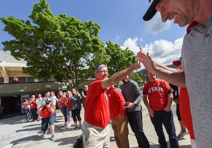 (Francisco Kjolseth  |  The Salt Lake Tribune)  University of Utah athletic director Chris Hill says goodbye to friends and staff, including men's basketball coach Larry Krystkowiak at the Huntsman Center on Friday, June 1, 2018, before climbing aboard a red Ute-branded Holiday Motor coach bus to the sounds of cheers and applause after 31 years on the job.