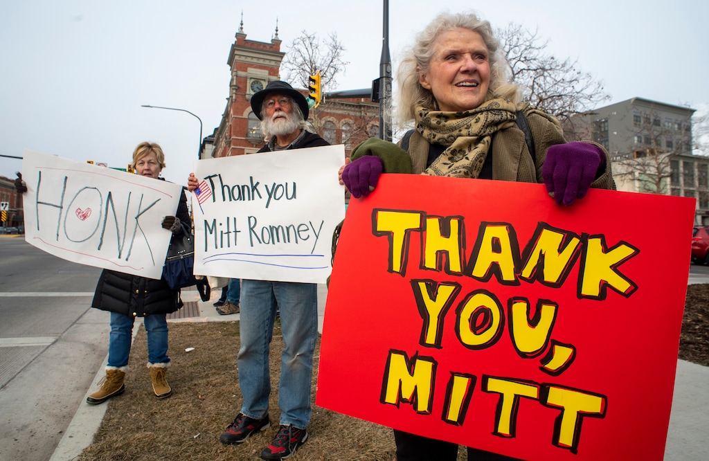 (Rick Egan  |  The Salt Lake Tribune)      Lisa Clark, Larry Harper and Charlotte England wave at cars on Center Street in Provo, during a rally to thank Mitt Romney for voting to convict President Trump, in the impeachment vote, Wednesday, Feb. 5, 2020. 