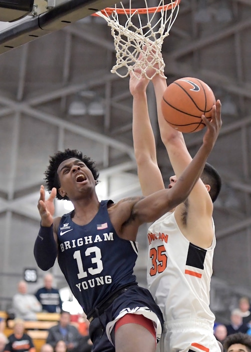 BYU guard Kajon Brown (13) goes up with a shot as he gets by Princeton forward Alec Brennan (35) during the first half of an NCAA college basketball game, Wednesday, Nov. 15, 2017, in Princeton, N.J. (AP Photo/Bill Kostroun)