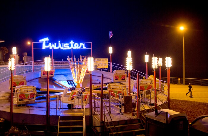 (David Goldman | The Associated Press)  A child walks past a ride sitting empty at an amusement park along the boardwalk ahead of Hurricane Irma in Daytona Beach, Fla., Thursday, Sept. 7, 2017. South Florida officials are expanding evacuation orders as Hurricane Irma approaches, telling more than a half-million people to seek safety inland.