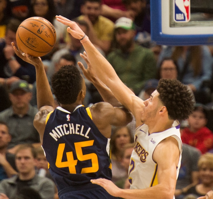 (Rick Egan  |  The Salt Lake Tribune)  Utah Jazz guard Donovan Mitchell (45) shoots as Los Angeles guard Lonzo Ball (2) defends for the lakers, Saturday, October 28, 2017.


