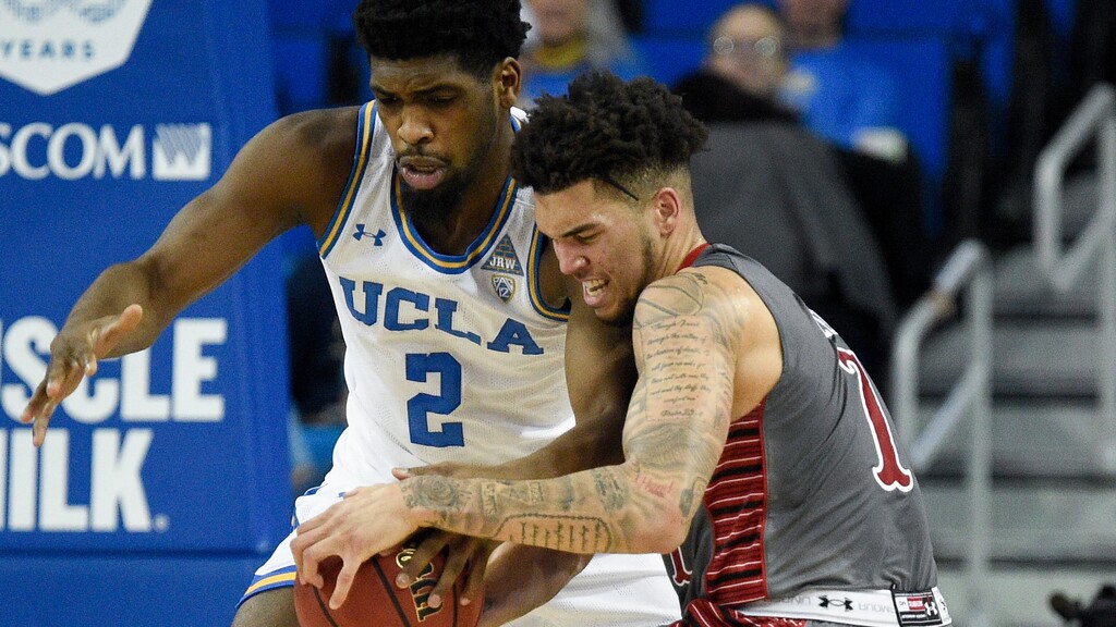 UCLA forward Cody Riley, left, steals the ball from Utah forward Timmy Allen during the first half of an NCAA college basketball game in Los Angeles, Sunday, Feb. 2, 2020. (AP Photo/Kelvin Kuo)