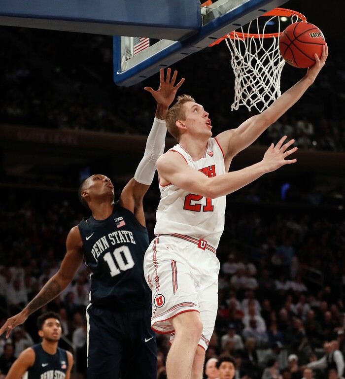 Utah forward Tyler Rawson (21) shoots against Penn State guard Tony Carr (10) during the first quarter of an NCAA college basketball game for the NIT championship Thursday, March 29, 2018, in New York. (AP Photo/Julie Jacobson)