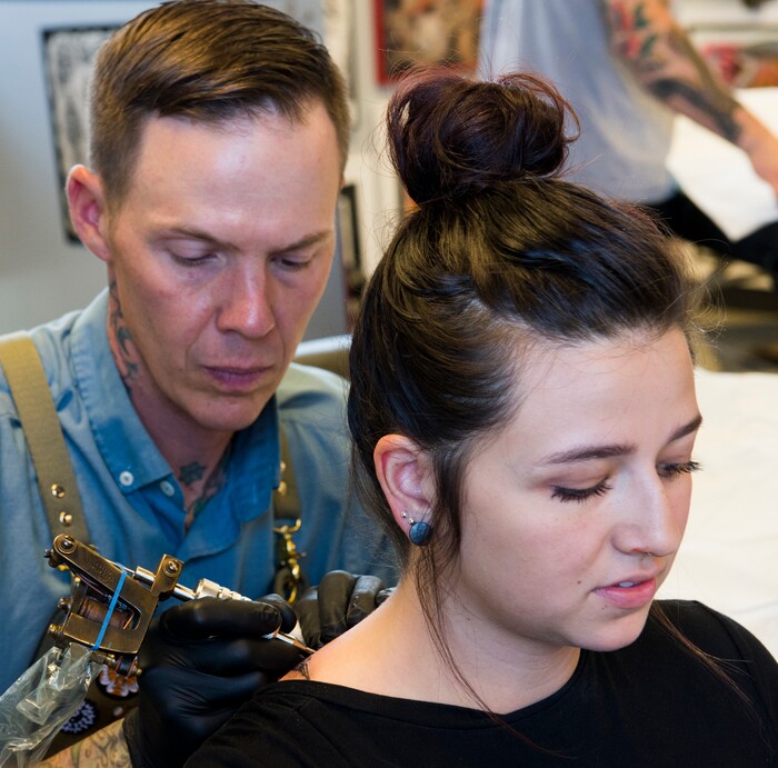 (Rick Egan | The Salt Lake Tribune) Sienna Stokes gets a tattoo from Jon Chatelain, at the Yellow Rose Tattoo. during a flash tattoo event where all proceeds go to the Rape Recovery Center of Utah. It's part of a national event where tattoo shops raise money for sexual assault victims. Sunday, June 10, 2018.