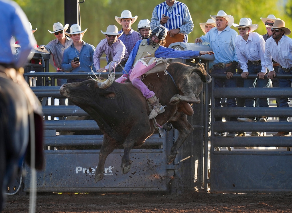 (Bethany Baker  |  The Salt Lake Tribune) Braxton Farnsworth competes in the bull riding competition during the Utah High School Rodeo Association state finals in Heber City on Wednesday, June 4, 2025. 