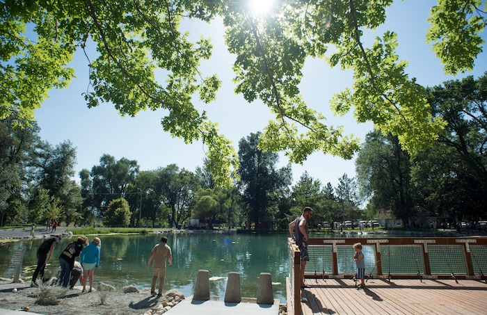 (Rick Egan  |  The Salt Lake Tribune)       Kids fish at Fairmont Park Pond, during the grand reopening celebration, Wednesday, June 27, 2018.