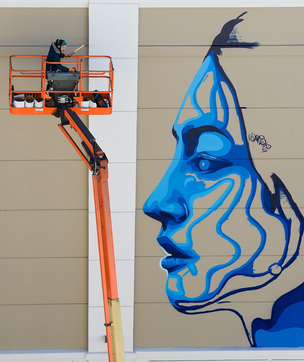 (Francisco Kjolseth | The Salt Lake Tribune) Artist Dourone works on a mural outside Clark Planetarium on Monday, Oct. 9, 2017.