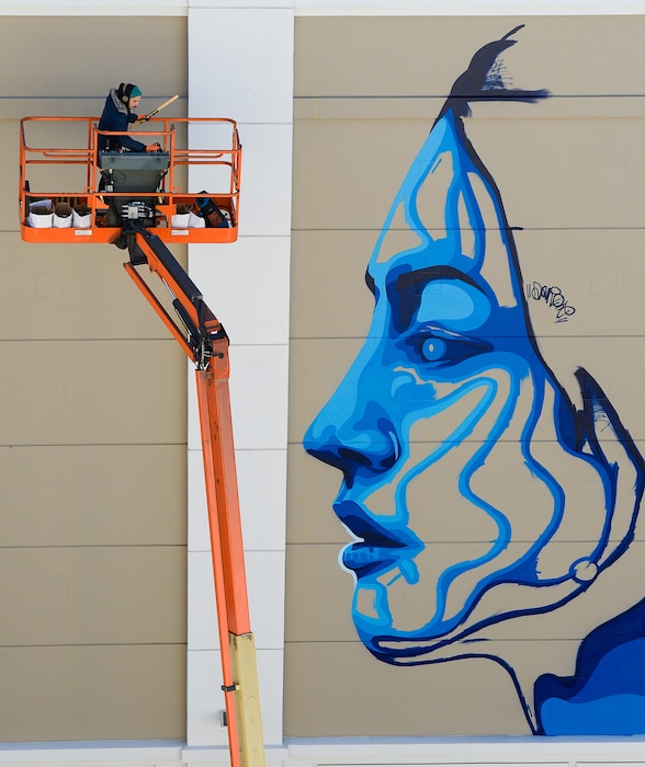 (Francisco Kjolseth | The Salt Lake Tribune) Artist Dourone works on a mural outside Clark Planetarium on Monday, Oct. 9, 2017.