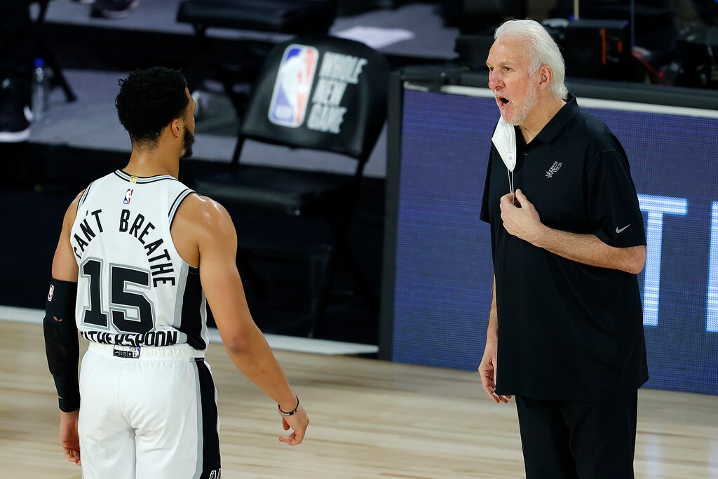 San Antonio Spurs head coach Gregg Popovich talks with Quinndary Weatherspoon (15) during the second half of an NBA basketball game against the Utah Jazz, Friday, Aug. 7, 2020, in Lake Buena Vista, Fla. (Kevin C. Cox/Pool Photo via AP)