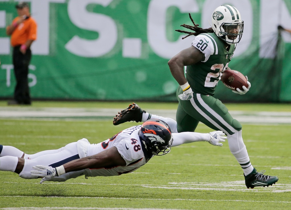 New York Jets' Isaiah Crowell (20) runs away from Denver Broncos' Shaquil Barrett (48) during the second half of an NFL football game Sunday, Oct. 7, 2018, in East Rutherford, N.J. (AP Photo/Seth Wenig)