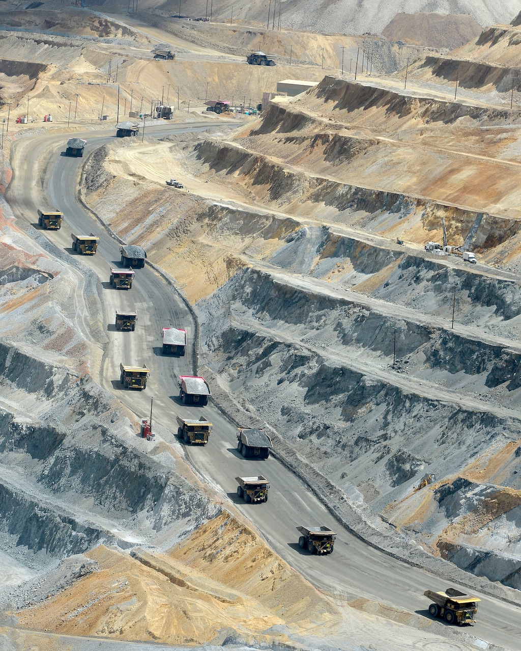 (Al Hartmann | Tribune file photo) Huge hauling trucks that hold 320 tons of material drive uphill to leave the open pit at Rio Tinto Kennecott to dump their loads, seen here in June 2017. The Salt Lake City-based mining company and its related operations account for more than 90 percent of all emissions in Utah listed on the U.S. Environmental Protection Agency’s toxic release inventory, or TRI.