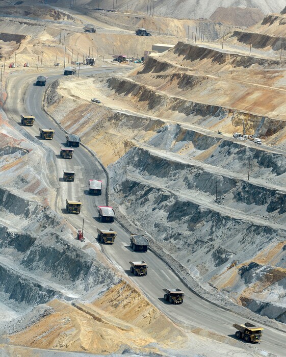 (Al Hartmann | Tribune file photo) Huge hauling trucks that hold 320 tons of material drive uphill to leave the open pit at Rio Tinto Kennecott to dump their loads, seen here in June 2017. The Salt Lake City-based mining company and its related operations account for more than 90 percent of all emissions in Utah listed on the U.S. Environmental Protection Agency’s toxic release inventory, or TRI.
