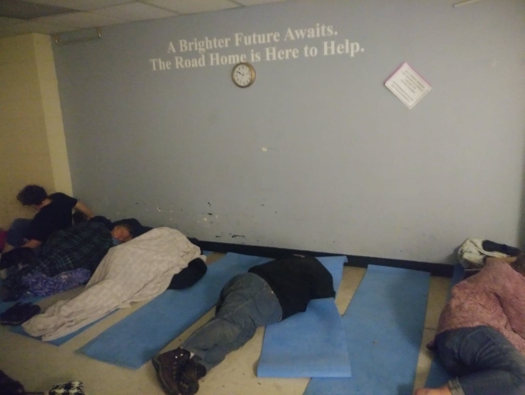(photo courtesy Christine Ireland)  People sleep on the floor at the Road Home in Salt Lake City in the early morning hours on January 25, 2019.