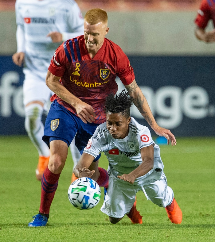 (Rick Egan  |  The Salt Lake Tribune).  Real Salt Lake defender Justen Glad (15) picks up a yellowfins card as he collides with Los Angeles FC forward Latif Blessing (7), in MLS soccer action between Real Salt Lake and Los Angeles FC at Rio Tinto Stadium, on Wednesday, Sept. 9, 2020.


