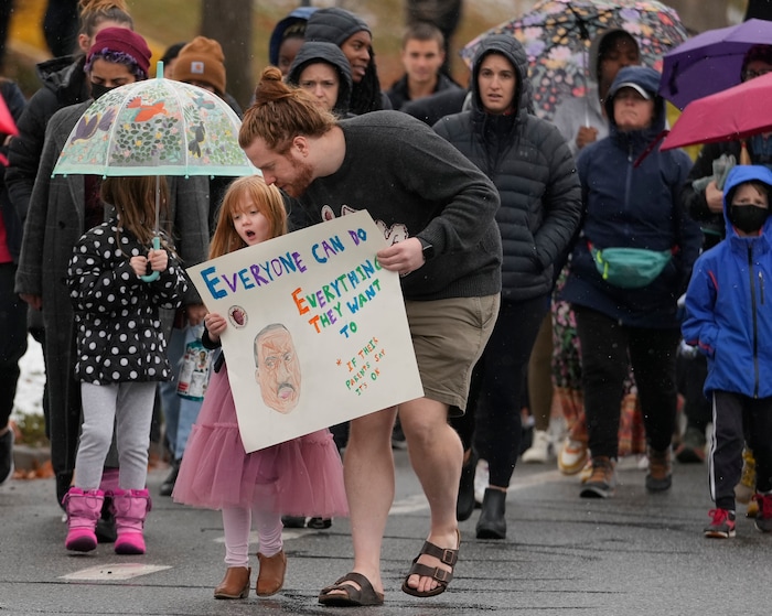 (Leah Hogsten | The Salt Lake Tribune) Sam Turner and his daughter Shirley, 5, walk in the march from East High School to Kingsbury Hall on Monday. To commemorate the legacy and work of Martin Luther King, Jr. and many other activists fighting for racial equality during the Civil Rights movement, the University of Utah's office of Equity, Diversity & Inclusion kicked off MLK Week 2023 with a rally at East High School, followed by a march to Kingsbury Hall, Jan. 16, 2023. 