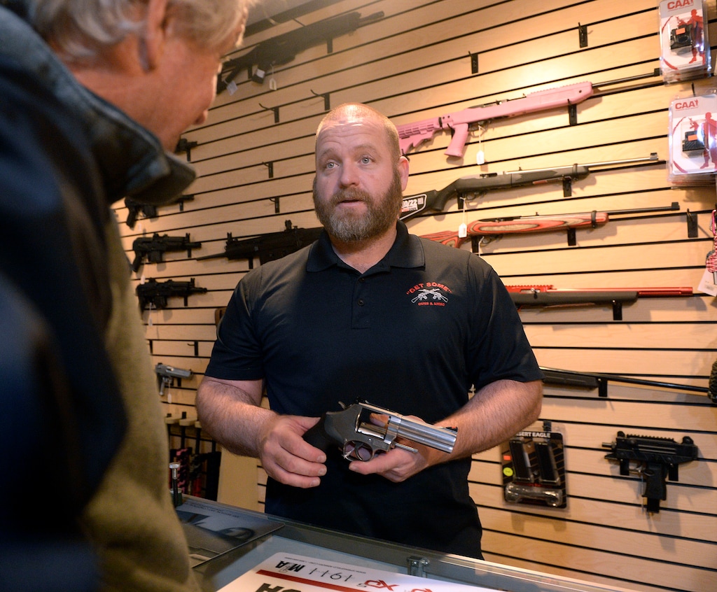 (Al Hartmann | Tribune file photo) Stuart Wallin, owner of Get Some Guns and Ammo helps customer with advice on a handgun at the flagship store in Murray on Jan. 8, 2017. Utah’s rate of gun sales has grown more quickly than any other state during the past decade.