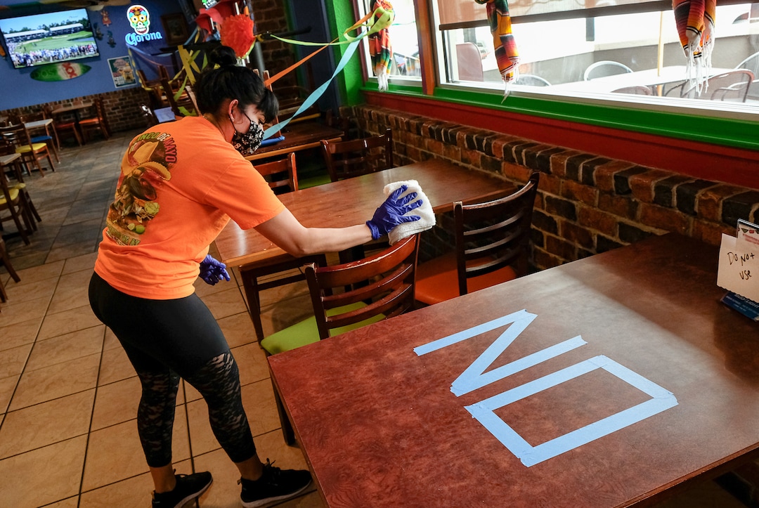 (Francisco Kjolseth  |  The Salt Lake Tribune) Lucy Walker thoroughly cleans a table at El Chihuahua. The Mexican restaurant in Holladay opened for sit-down dining on Friday, May 1, 2020.