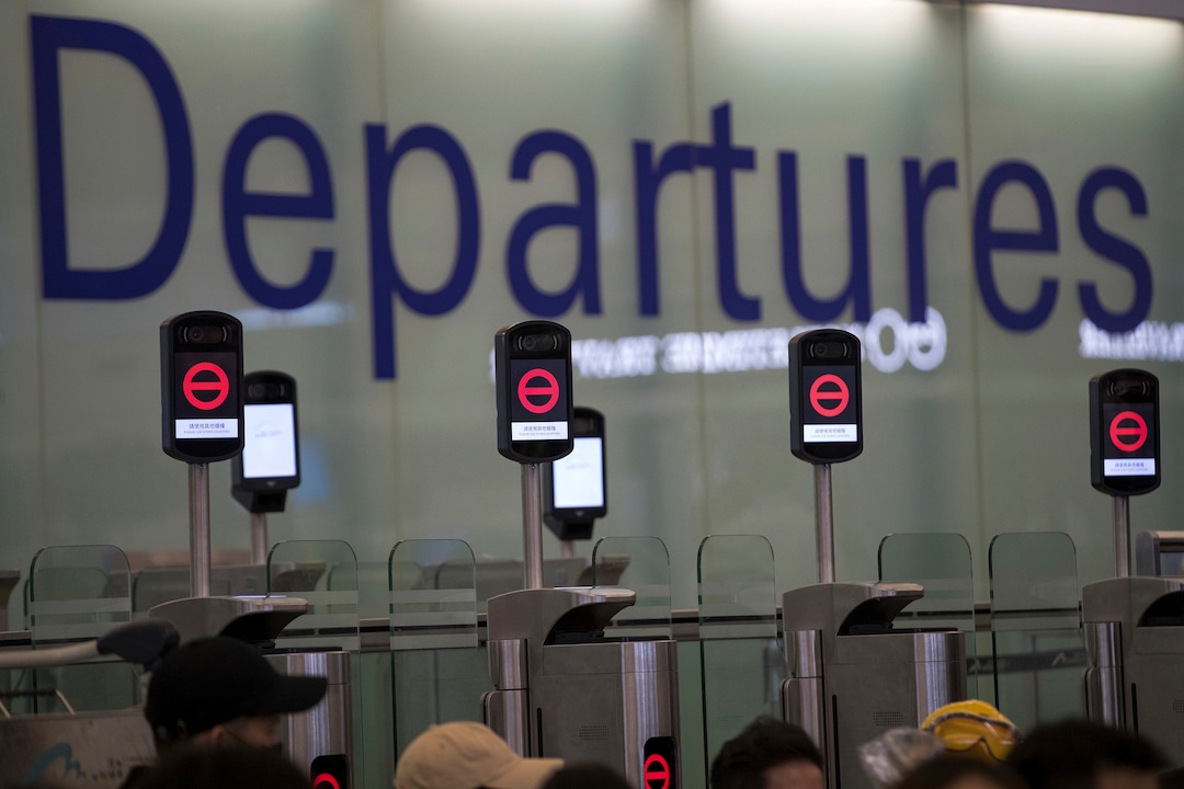 (Vincent Thian | AP Photo) Protesters gather near the departure gates showing no entry as they stage a sit-in rally at the Hong Kong International Airport in Hong Kong, Tuesday, Aug. 13, 2019. Protesters severely crippled operations at Hong Kong's international airport for a second day Tuesday, forcing authorities to cancel all remaining flights out of the city after demonstrators took over the terminals as part of their push for democratic reforms.