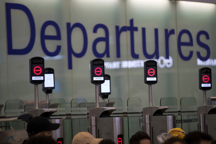 (Vincent Thian | AP Photo) Protesters gather near the departure gates showing no entry as they stage a sit-in rally at the Hong Kong International Airport in Hong Kong, Tuesday, Aug. 13, 2019. Protesters severely crippled operations at Hong Kong's international airport for a second day Tuesday, forcing authorities to cancel all remaining flights out of the city after demonstrators took over the terminals as part of their push for democratic reforms.