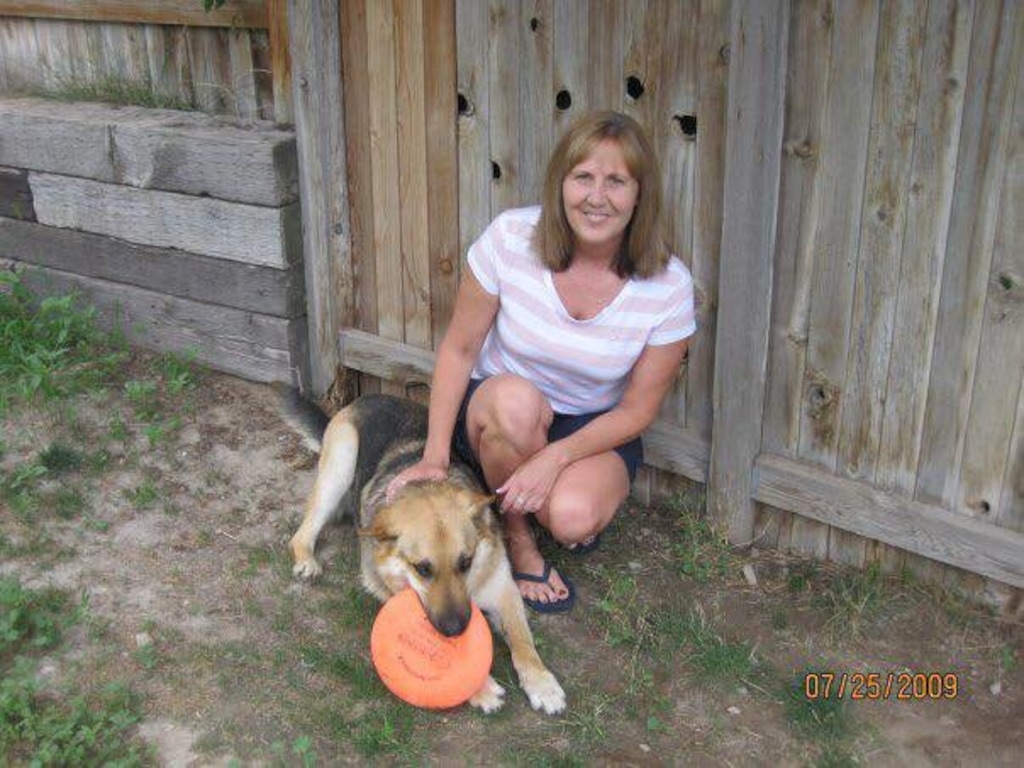 (Photo courtesy of Halie and Katie Merrill) Jill Robinson smiles with her dog in this undated family photo.