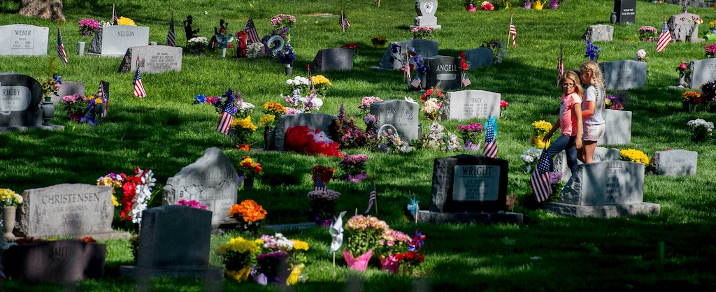 (Steve Griffin | Tribune file photo)
Children walk through flowers and American flags at the Kaysville City Cemetery as Kaysville Parks & Recreation, American Legion Post 27 and Lindquist Mortuaries welcome and honor veterans in a Memorial Day celebration, May 30, 2016.