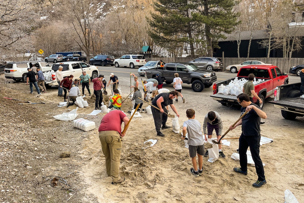(Trent Nelson | The Salt Lake Tribune) Sandbags are filled as waters rise in Emigration Canyon on Wednesday, April 12, 2023. State lawmakers have approved emergency funding so municipalities will be able to be reimbursed for some flood relief efforts this spring and summer, Utah Gov. Spencer Cox told reporters on Thursday, May 18, 2023.