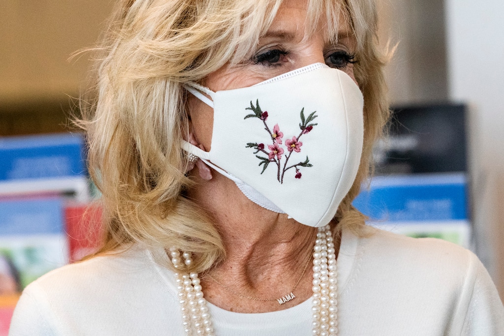 First lady Jill Biden's necklace says "Mama," as she takes a tour of Whitman-Walker Health, Friday, Jan. 22, 2021, in Washington. (AP Photo/Jacquelyn Martin, Pool)