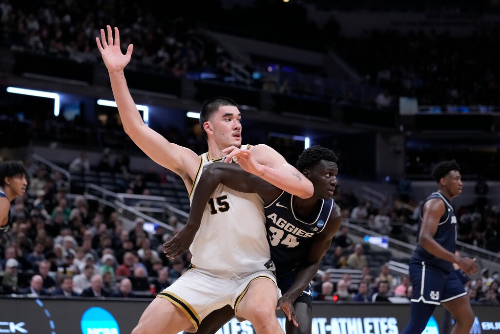 (Michael Conroy | AP) Purdue's Zach Edey (15) looks for a pass under the basket as Utah State's Kalifa Sakho (34) defends during the second half of a second-round college basketball game in the NCAA Tournament, Sunday, March 24, 2024 in Indianapolis.