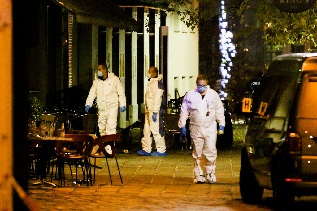 (Ronald Zak | AP) Three persons investigate at the scene following gunfire on people enjoying a last evening out before lockdown in the Austrian capital Vienna, Tuesday, Nov. 3, 2020. Police in the Austrian capital said several shots were fired shortly after 8 p.m. local time on Monday, Nov. 2, in a lively street in the city center of Vienna. Austria's top security official said authorities believe there were several gunmen involved and that a police operation was still ongoing.