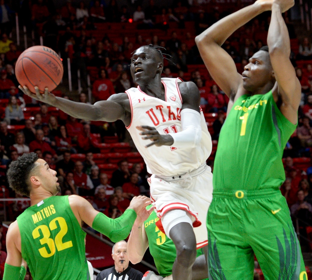 (Leah Hogsten  |  The Salt Lake Tribune) Utah Utes guard Both Gach (11) drives the court past the Ducks defense as the University of Utah basketball team hosts No. 4 Oregon, Jan. 4, 2020, at the Huntsman Center.