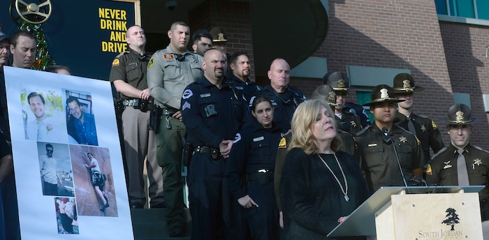 (Al Hartmann | The Salt Lake Tribune) Members of the South Jordan Police and Utah Highway Patrol stand with Jan McMillian at a press conference about the dangers of driving drunk on Thursday, Dec. 14, 2017. She described their family's loss when a drunken driver, who was driving the wrong direction on I-215, killed their adult son, Mikey, in 2015. South Jordan Police and the Utah Highway Patrol said that there will be increased patrols and enforcement over the holiday to catch drunken drivers.