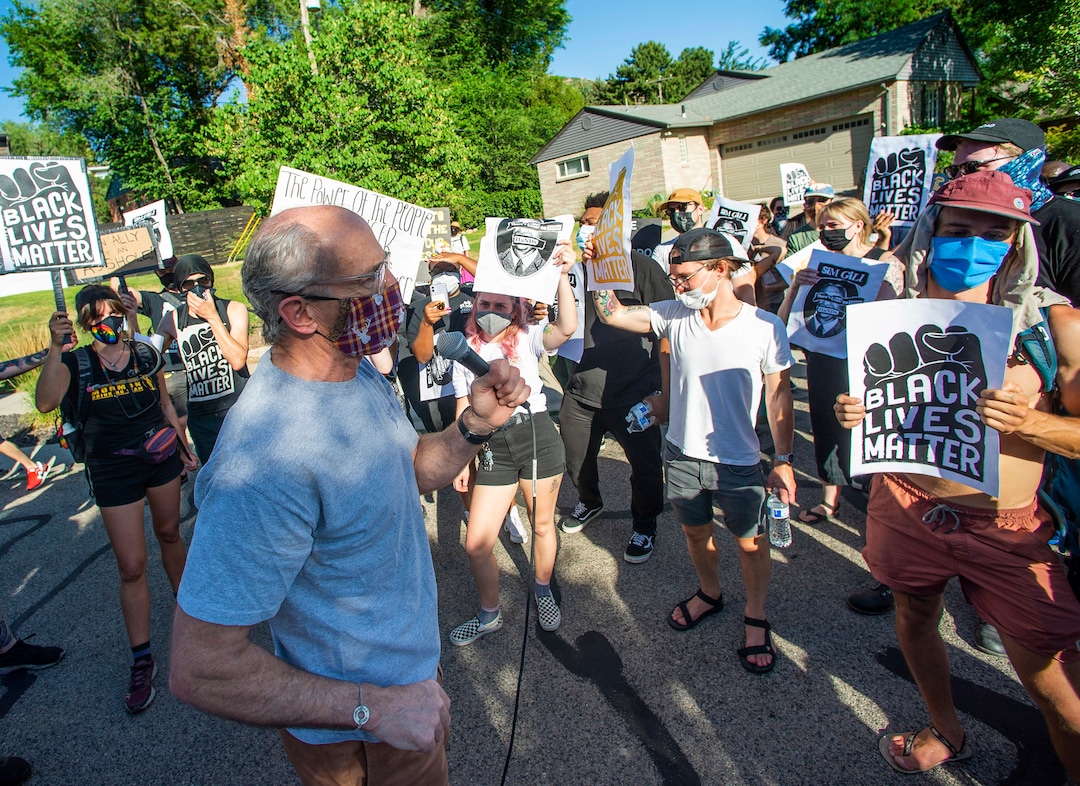(Rick Egan  |  The Salt Lake Tribune)      Salt Lake City Councilman, Dan Dugan,  talks to protesters as they march through his neighborhood, during a march for Justice in Salt Lake City, on Sunday, July 12, 2020.