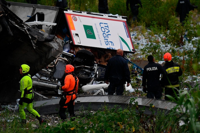 Rescues work among the debris of the collapsed Morandi highway bridge in Genoa, Tuesday, Aug. 14, 2018. Italian authorities say that about 10 vehicles were involved when the raised highway collapsed during a sudden and violent storm in the northern port city of Genoa, while private broadcaster Sky TG24 said the collapsed section was about 200-meter long (650 feet). (Luca Zennaro/ANSA via AP)