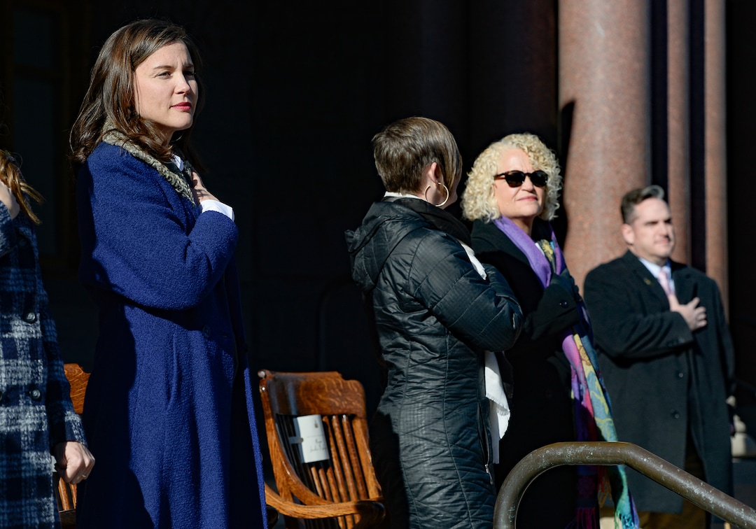 (Francisco Kjolseth  |  The Salt Lake Tribune) Erin Mendenhall, left, covers her heart during the National Anthem prior to being sworn in as Salt Lake City's new Mayor on Monday, Jan. 6, 2020. At right is outgoing Mayor Jackie Biskupski.