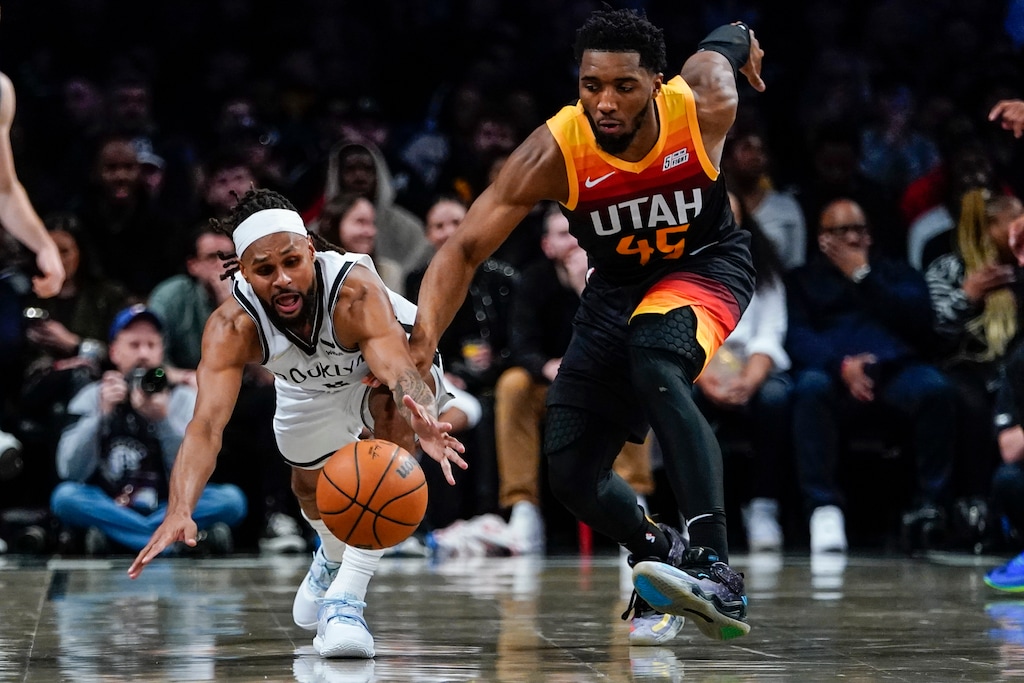 Brooklyn Nets' Patty Mills, left, of Australia, fights for control of the ball with Utah Jazz's Donovan Mitchell (45) during the second half of an NBA basketball game Monday, March 21, 2022, in New York. (AP Photo/Frank Franklin II)