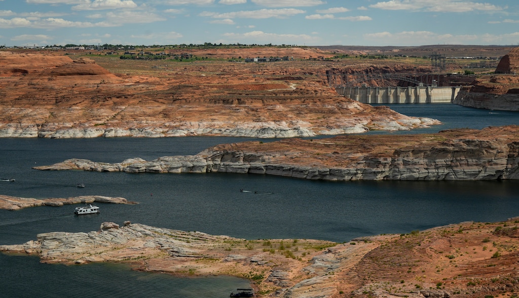 (Bethany Baker | The Salt Lake Tribune) Boaters recreate on Lake Powell near Glen Canyon Dam near Page, Ariz. on Thursday, July 13, 2023. The Bureau of Reclamation reported that Lake Powell will receive 2 million acre-feet less water than originally forecasted.