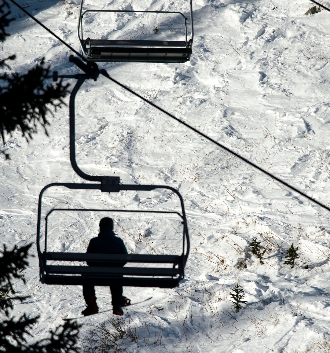 (Steve Griffin  |  The Salt Lake Tribune) A snowboarder rides a lift at Brighton ski area in Salt Lake City Monday January 1, 2018.