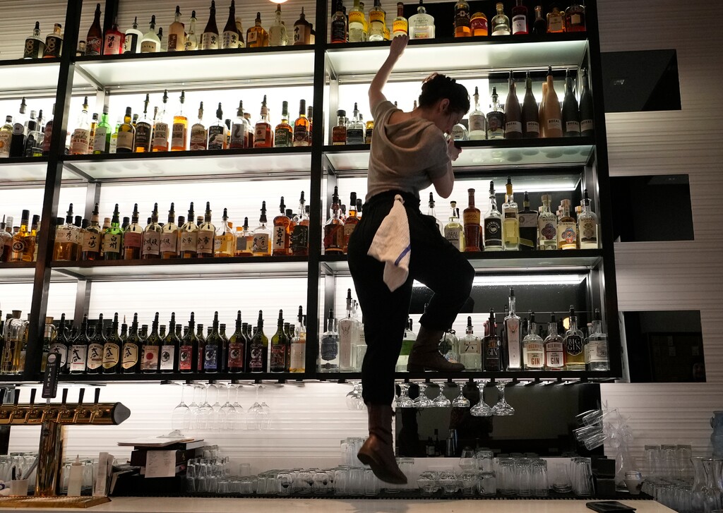 (Leah Hogsten | The Salt Lake Tribune) Post Office Place bartendress April Long retrieves a bottle of liquor to make specialty cocktails Monday, February 13, 2023. Post Office Place has received national recognition as a semifinalist for the James Beard Awards in the "outstanding bar" category.