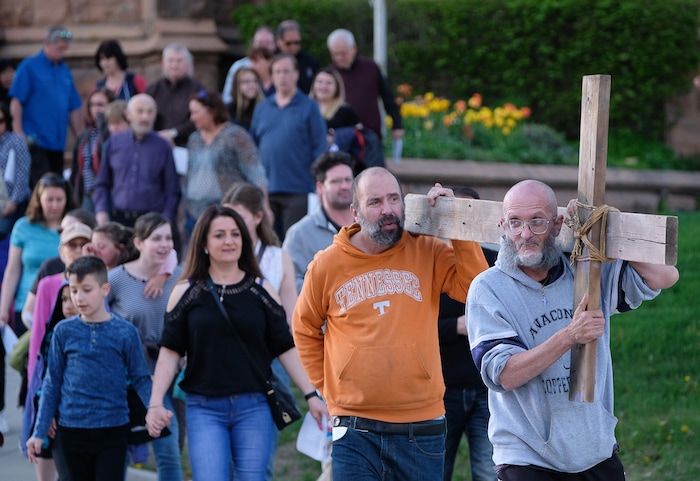 (Francisco Kjolseth  |  The Salt Lake Tribune)  Alex Bury, right, and Kent Kilburn take a turn carrying the cross as christians march through streets of Salt Lake City on Good Friday to symbolically mark Jesus' carrying the cross to his crucifixion beginning at Cathedral of the Madeleine.