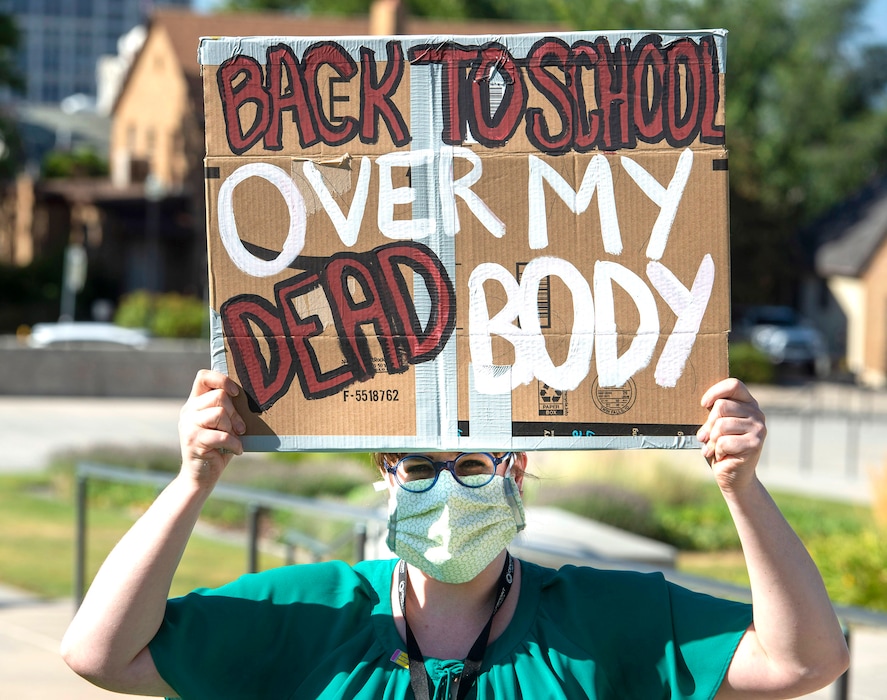 (Rick Egan | The Salt Lake Tribune file photo) Teacher Angela Andrus joins protesters during a rally organized by the Utah Education Association on Thursday, July 23, 2020, to speak out against unsafe conditions for educators with schools reopening. The union now is demanding that Gov. Gary Herbert force schools to close during outbreaks of the coronavirus.