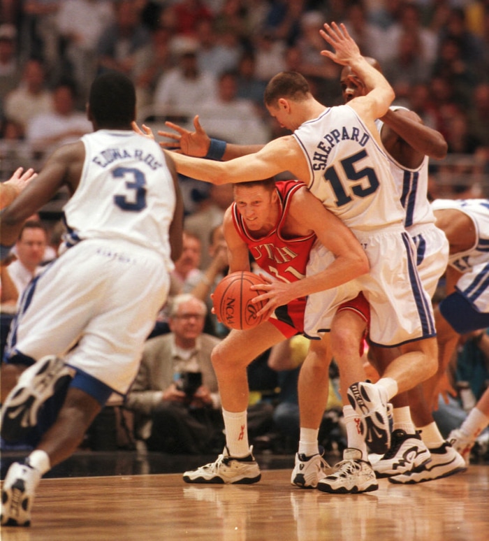 (Steve Griffin  |  Tribune file photo)  Utah's Britton Johnsen ducks under defense of Kentucky's Jeff Sheppard in the 1998 championship game in San Antonio, Texas. At left is Allen Edwards. 